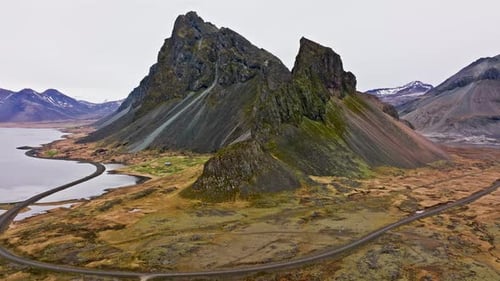 Drone View Focusing On Eystrahorn Mountain's Rocky Slope