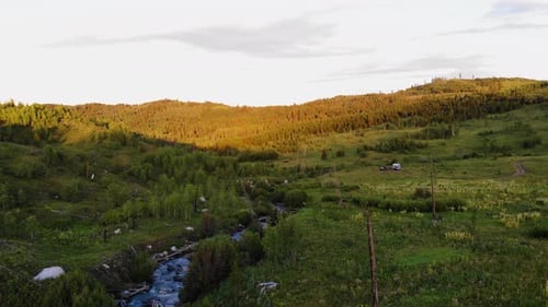 Aerial shot of a river in the woods of the Grand Teton Park.