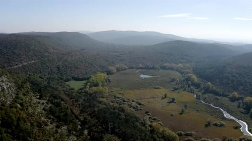 drone view of a valley in the mountains near trieste