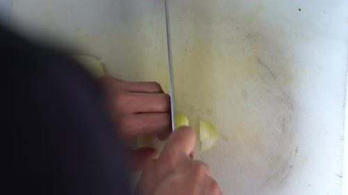 Professional kitchen hand, slicing brunoise cut the onion, preparing the ingredients for restaurant