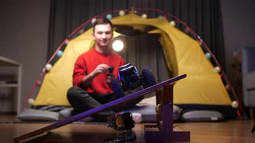 Young Adult Playing with Toys at Home