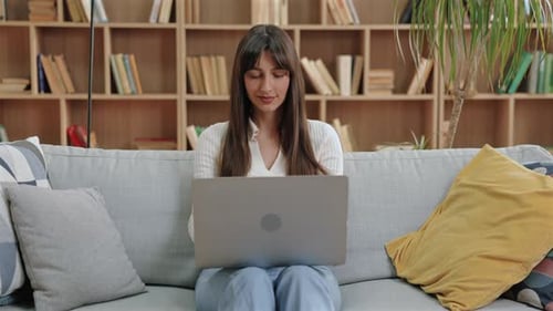 Young Woman Working on Laptop at Home