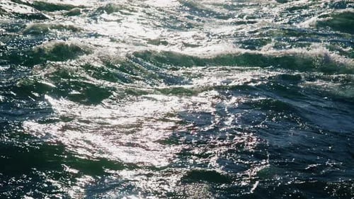 Glistening Waves in Bright Sunlight Tranquil Ocean Surface Footage Beautifully Showcasing Serenity
