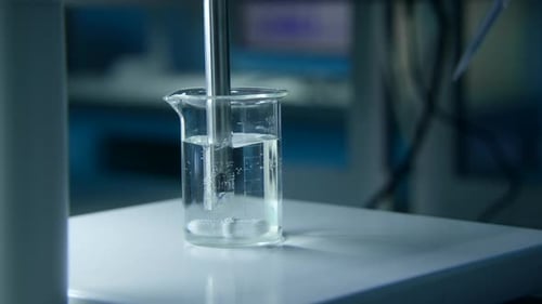 Laboratory Beaker With Water Being Mixed and Tested