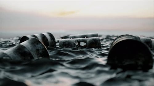 Empty Oil Barrels Float in a Sea of Oil