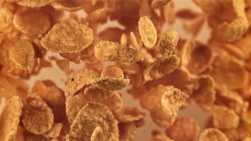 Crispy Corn Flakes Floating in Golden Light