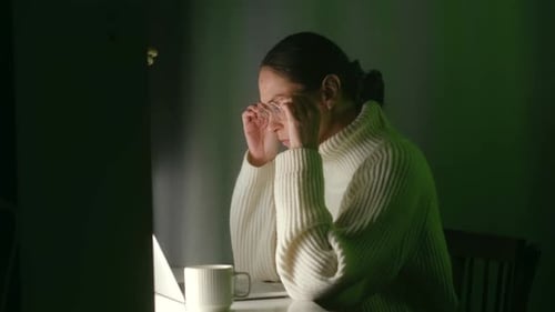 Woman Typing on Laptop at Night, Stressed and Tired