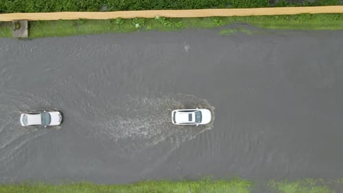 Aerial View of City Traffic with Cars Driving on Flooded Street After Heavy Rain