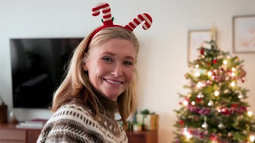Woman With Candy Cane Headband Smiling at Christmas
