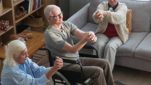 Nursing Home Residents Doing Seated Stretching