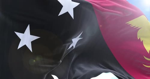 Papua New Guinea Flag Waving in Realistic Slow Motion with Blue Sky