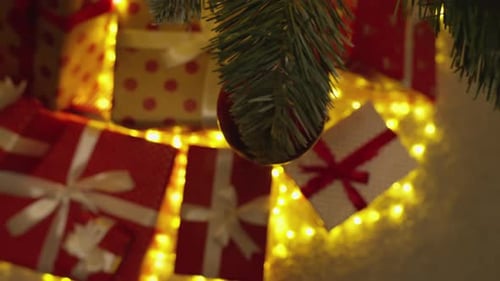 Christmas Presents Under a Lit Christmas Tree