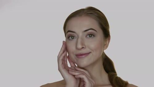 Woman Touches Her Face in a Beauty Shot