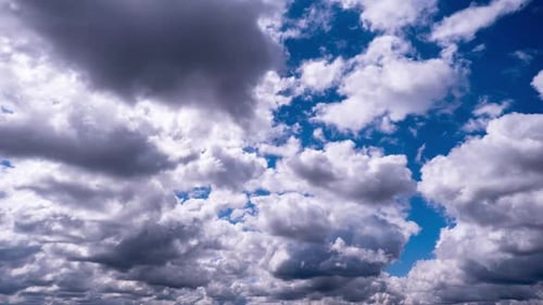 Billowing White Clouds Move Across a Vivid Blue Sky