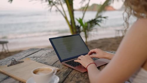 Female Developer Working on Laptop By the Ocean Young Woman Freelancer Coding at Outdoor Tropical