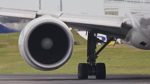Airplane Engine and Landing Gear Taxiing on Runway