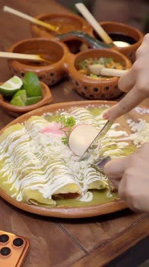 Cutting Authentic Mexican Enchiladas Verdes With Salsa and Cream