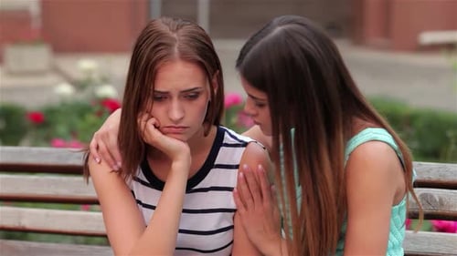 Woman Comforting Sad Friend on Bench
