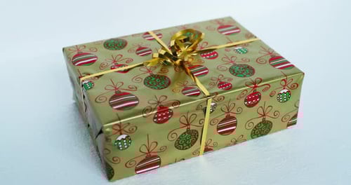 Christmas Gift Wrapped with Golden Ribbon and Ornaments