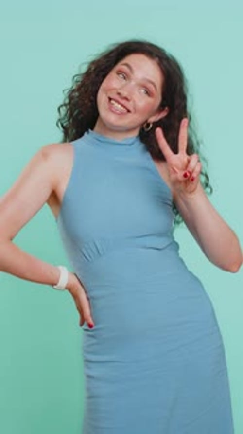 Woman Smiling and Holding Up Peace Sign