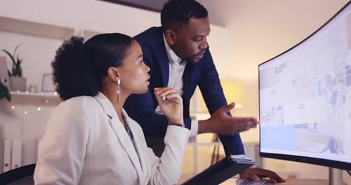 Business Colleagues Discussing Project at Office Computer