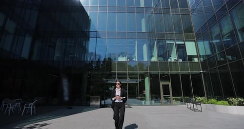 Young Businesswoman Walking in Central Business District in City Professional Woman Walking Outdoors
