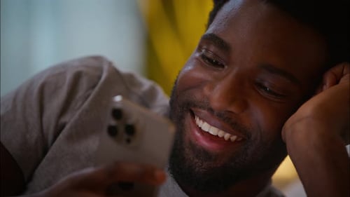 Happy Laughing Cheerful Customer Client Male User African American Man Guy Holding Mobile Phone