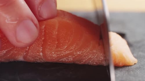 Sushi Chef Slices Fresh Raw Salmon on Professional Kitchen Close Up