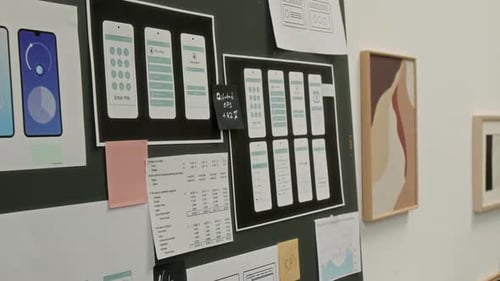 Printouts of Layout Concepts for Smartphone Applications on Wall at UX Startup