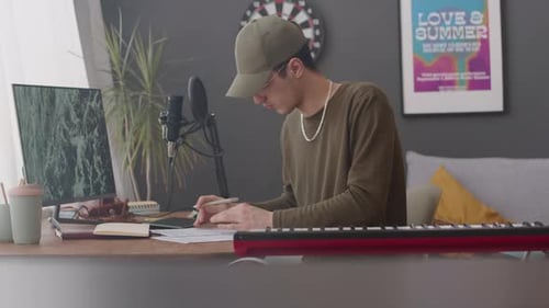 Young Adult Composing Music at Home Studio