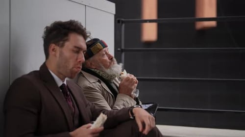 Two Men Share Lunch Break Outside Urban Building