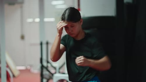 Young Female Boxer Shadow Boxing in the Gym