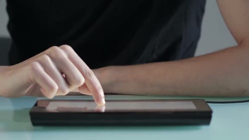 Man Using Tablet on a Desk Indoors