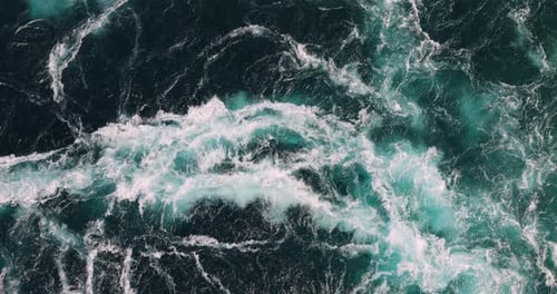Blue waves of water of the river and the sea meet each other during high tide and low tide.