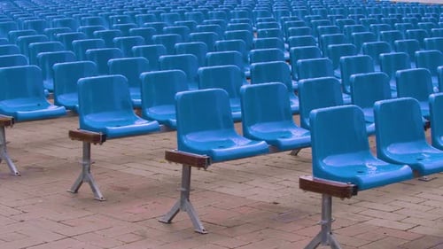 Rows of Empty Blue Chairs on Brick Ground