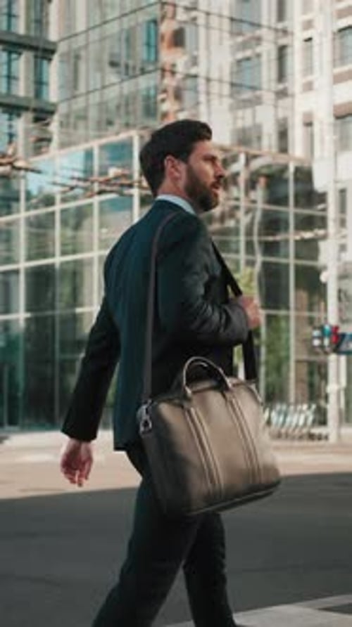 Businessman with Laptop in Bag Crosses Street at Crosswalk