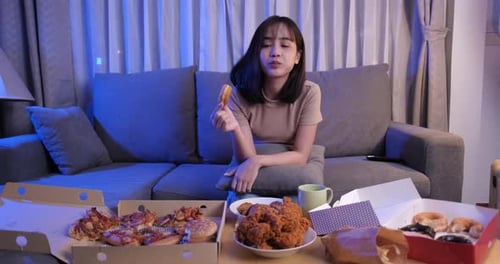 Young Woman Enjoys Midnight Feast at Home