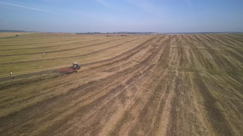 Tractor working on the field doing tillage with cultivator