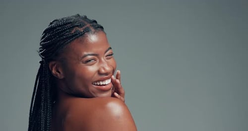 Laugh, shoulder and skincare with face of black woman in studio for body care, beauty and shine