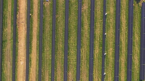 Aerial Drone View of a Large Field of Solar Panels Producing Green Renewable Energy