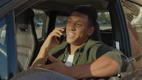 Young Adult Man Talking on the Phone in Car
