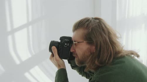 Photographer Working with Female Model during Photo Session in Studio