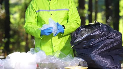 Volunteer Sorting and Collecting Plastic Waste in Nature