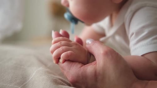 Baby Grasping Hand of an Adult with Love
