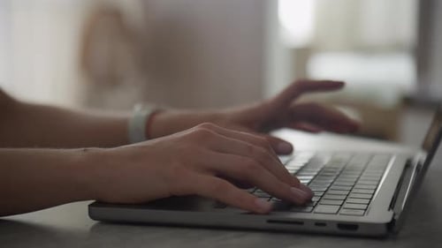 CloseUp of Hands Typing on Laptop Keyboard