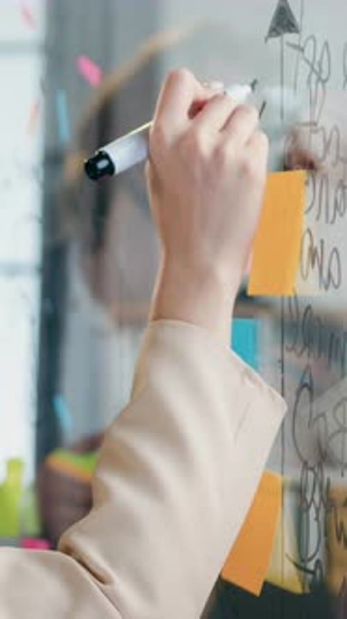 Office Work Concept Where Coalified Businessman and Woman Teammates Brainstorming New Ideas on Glass