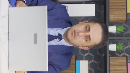 Man Talking on Video Call at His Desk