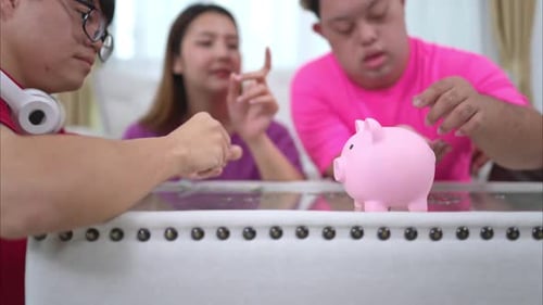 Three siblings save money by putting it in a piggy bank