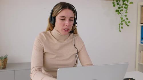 Smiling Female Operator Working with Telephone Headset in Call Center