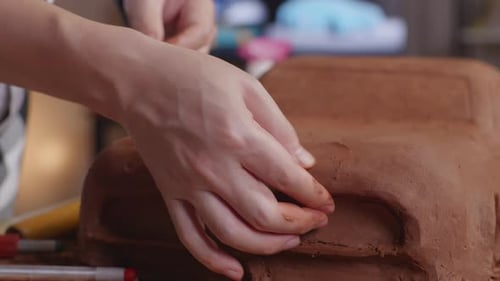 Close Up Of Designer's Hands Smooth Out The Surface And Create Details In The Sculpture Of Car Clay